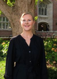 Woman outside smiling to camera